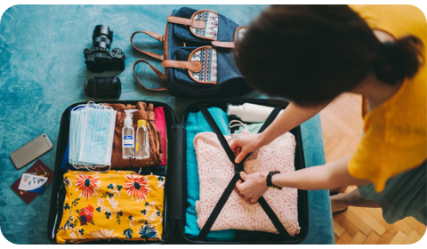 Woman packing a carry-on suitcase for travel